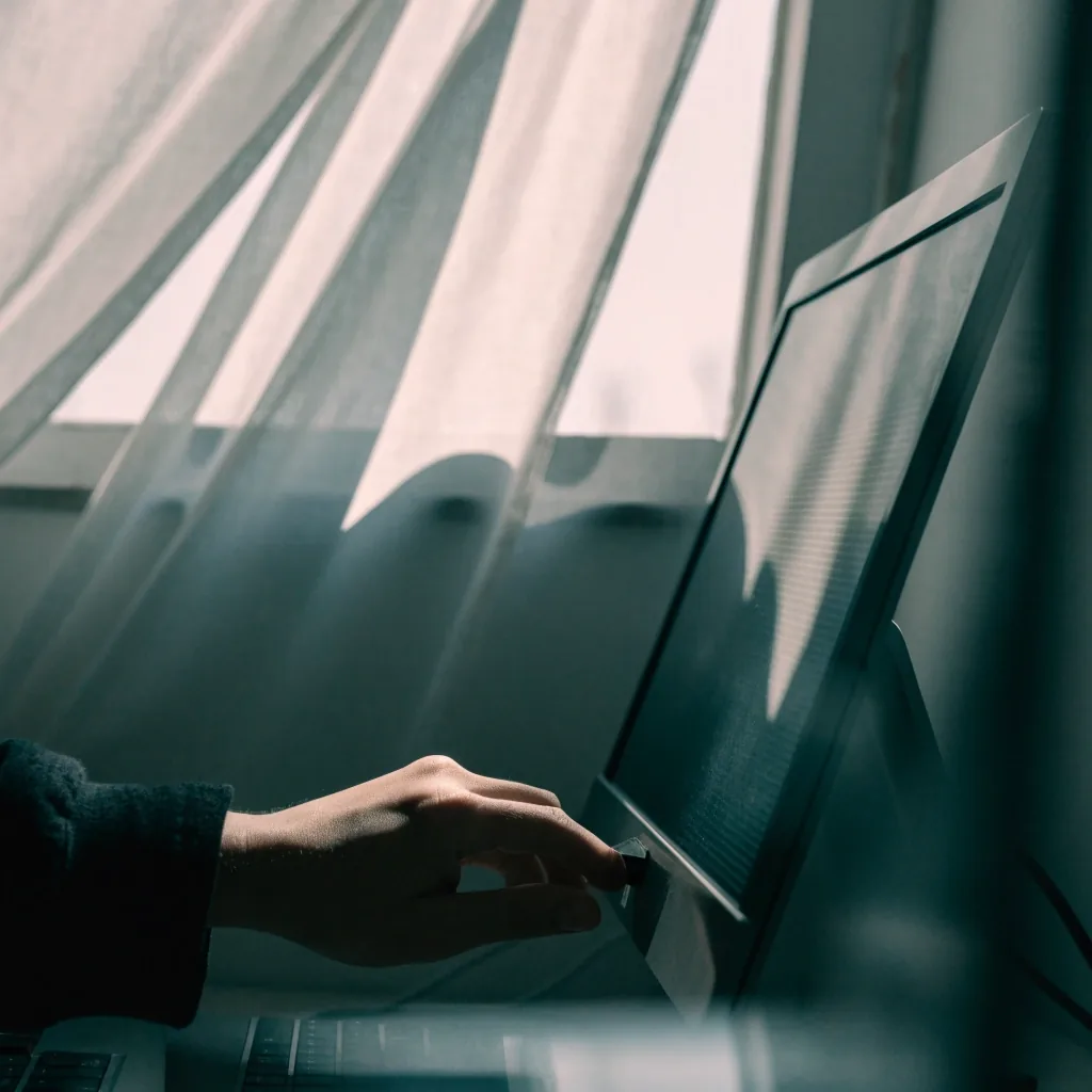 Humidifier mist column beside a keyboard in window light
